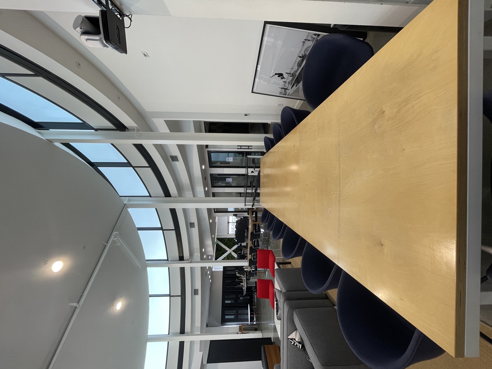 The long communal table under the curved glass rotunda