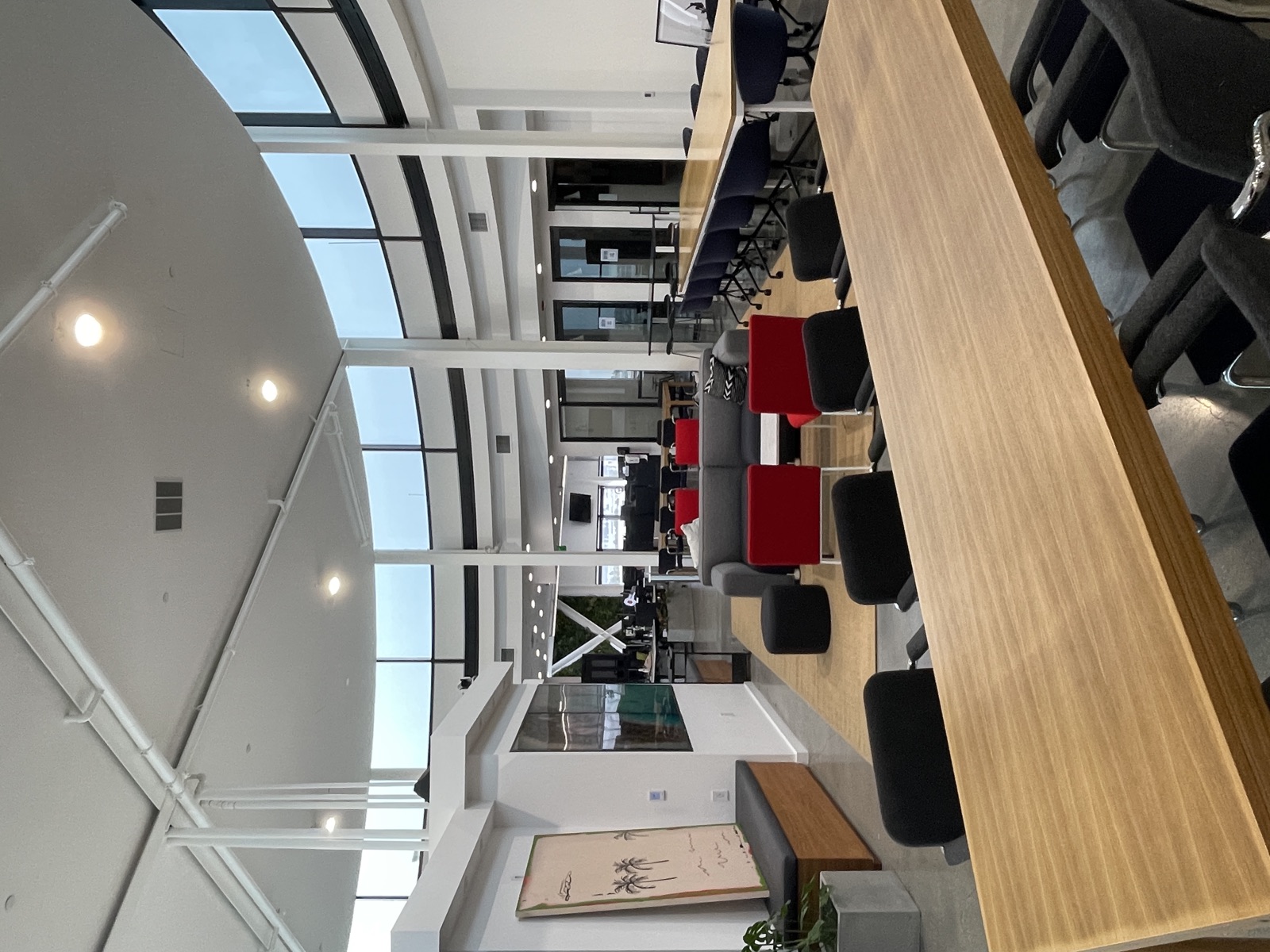 Panoramic view of the Circle rotunda office with red chairs and floor-to-ceiling glass